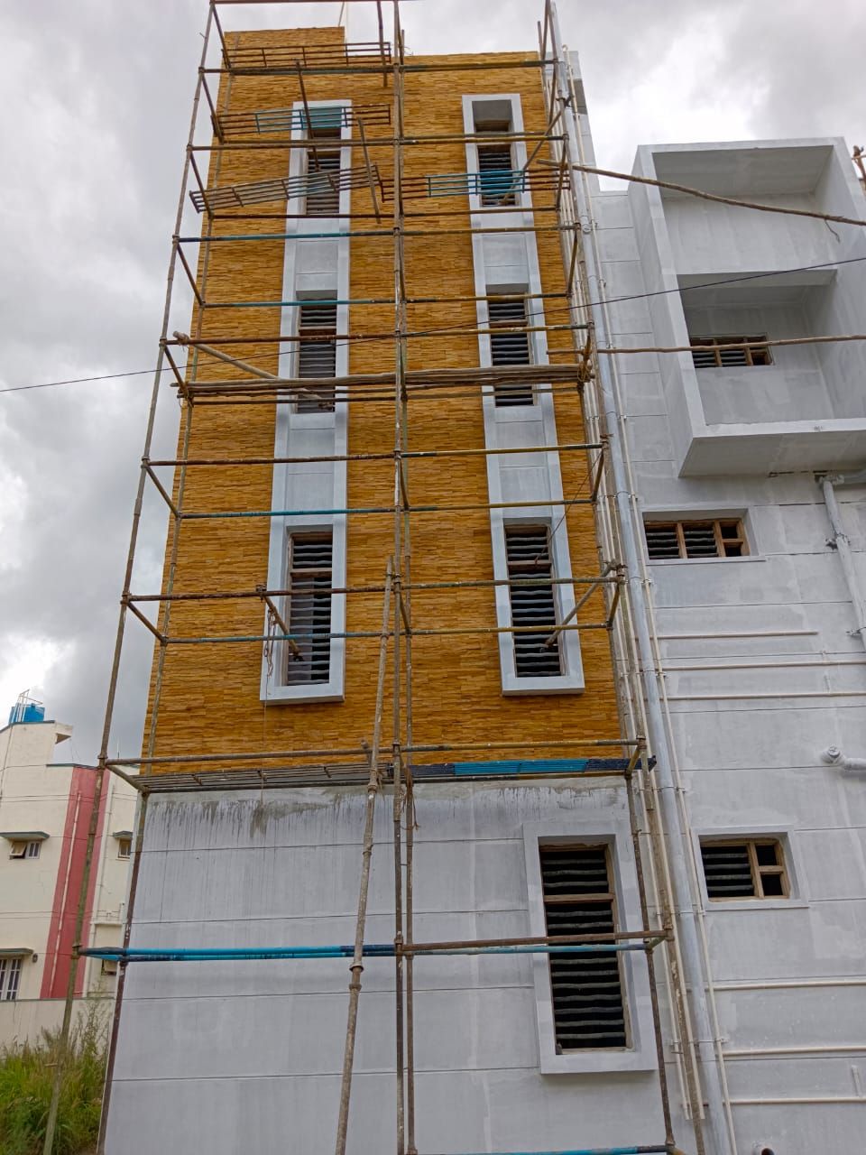 Stone facade cladding in progress on scaffolding